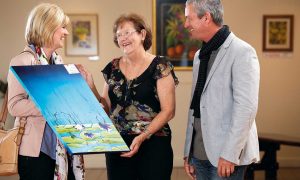 Elaine Madill and visitors viewing some of the art on display at the Wondail Art Gallery